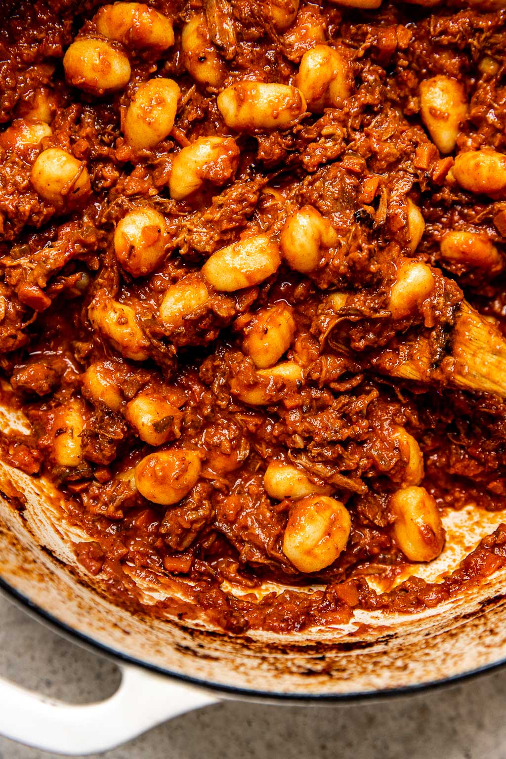 gnocchi tossed in shredded beef ragu in a Dutch oven 