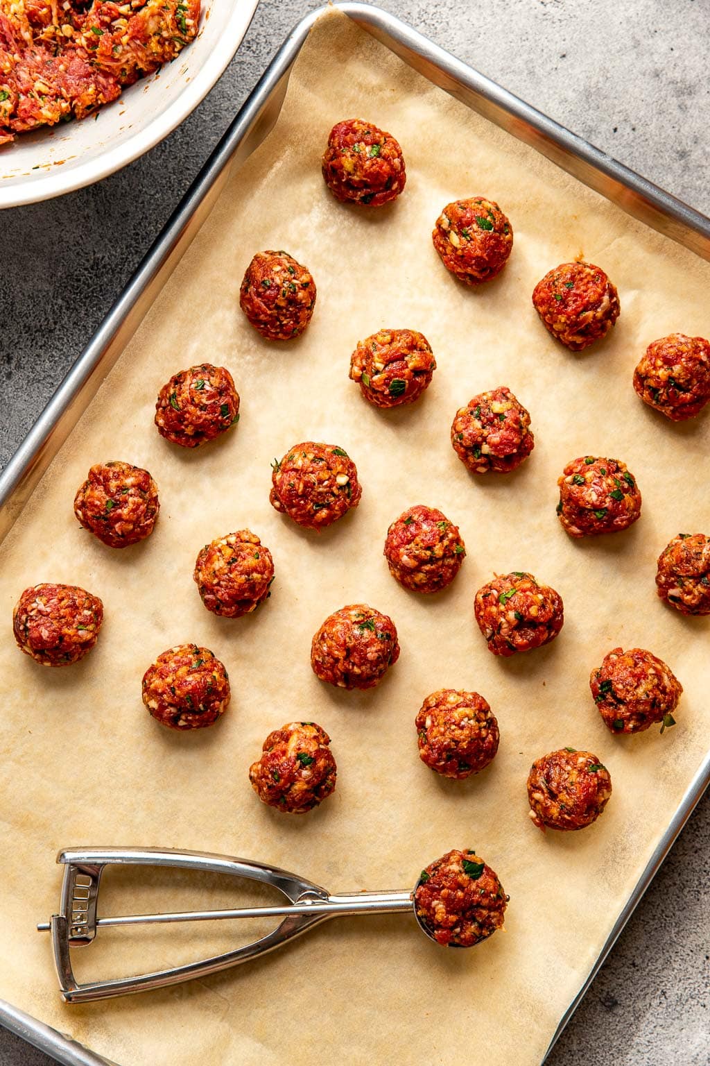 Unbaked meatballs on a baking sheet 