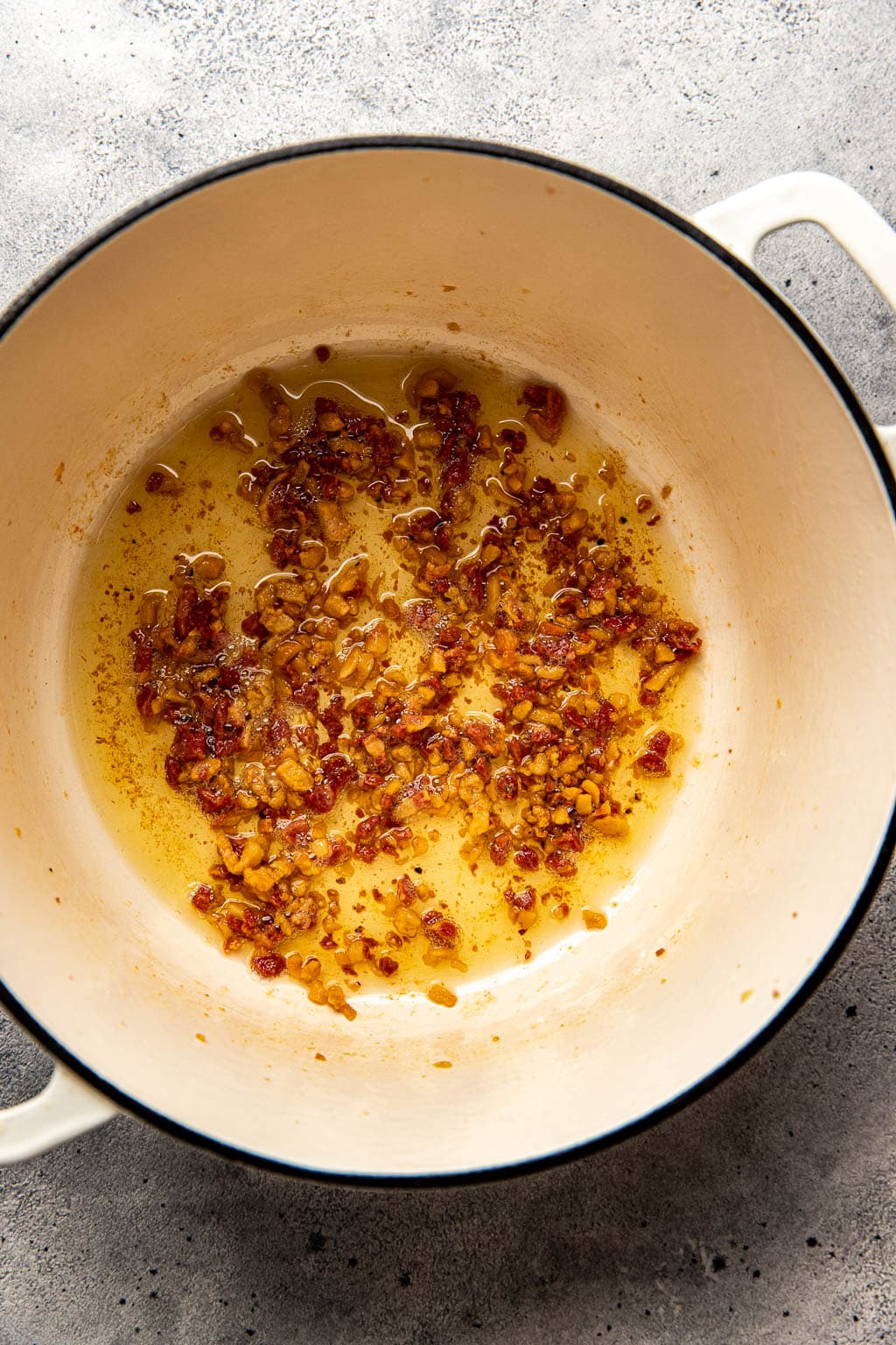 Rendered pancetta in a Dutch oven