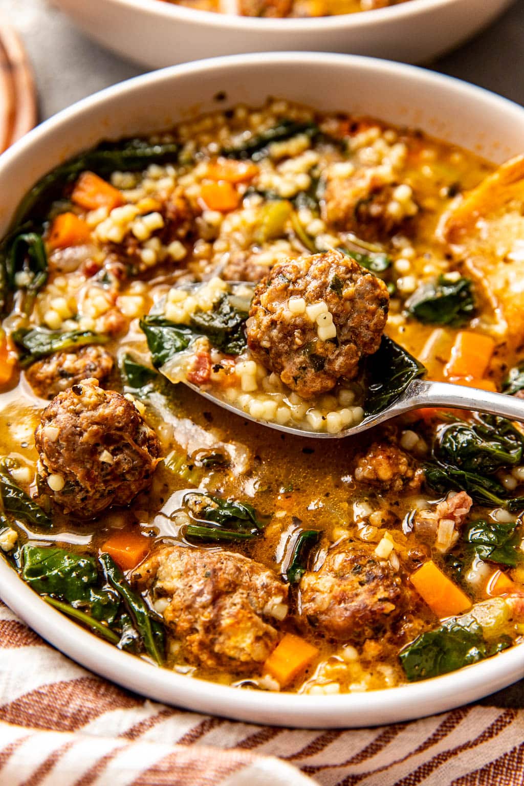 A bowl of Italian wedding soup with pastina pasta