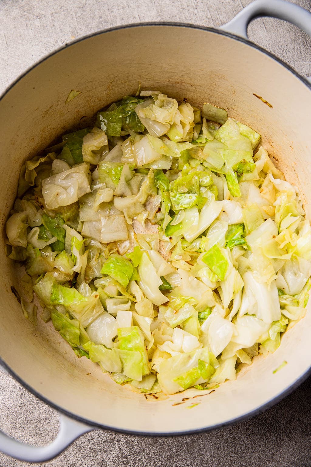 Sliced cabbage sautéing in Dutch oven