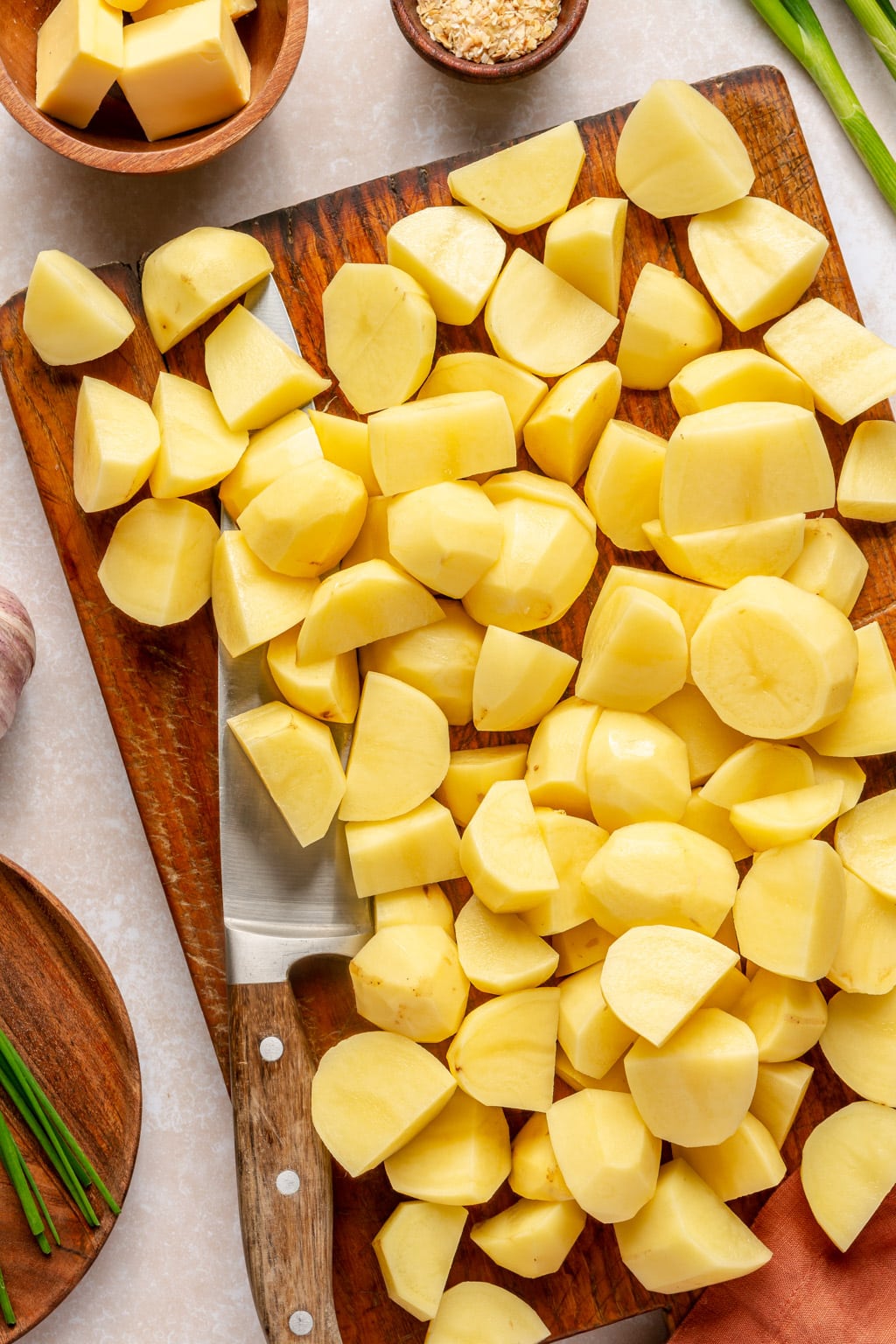 Potatoes being cut into chunks