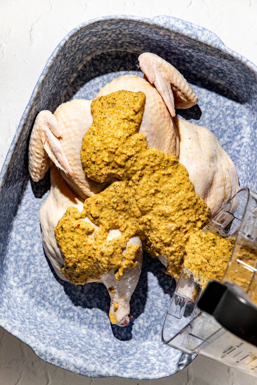 marinade being poured on the chicken