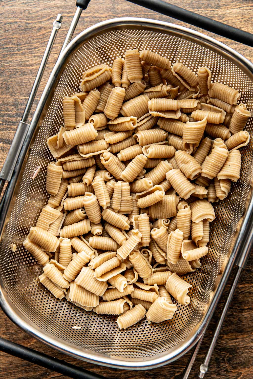 cooked pasta in a metal colander