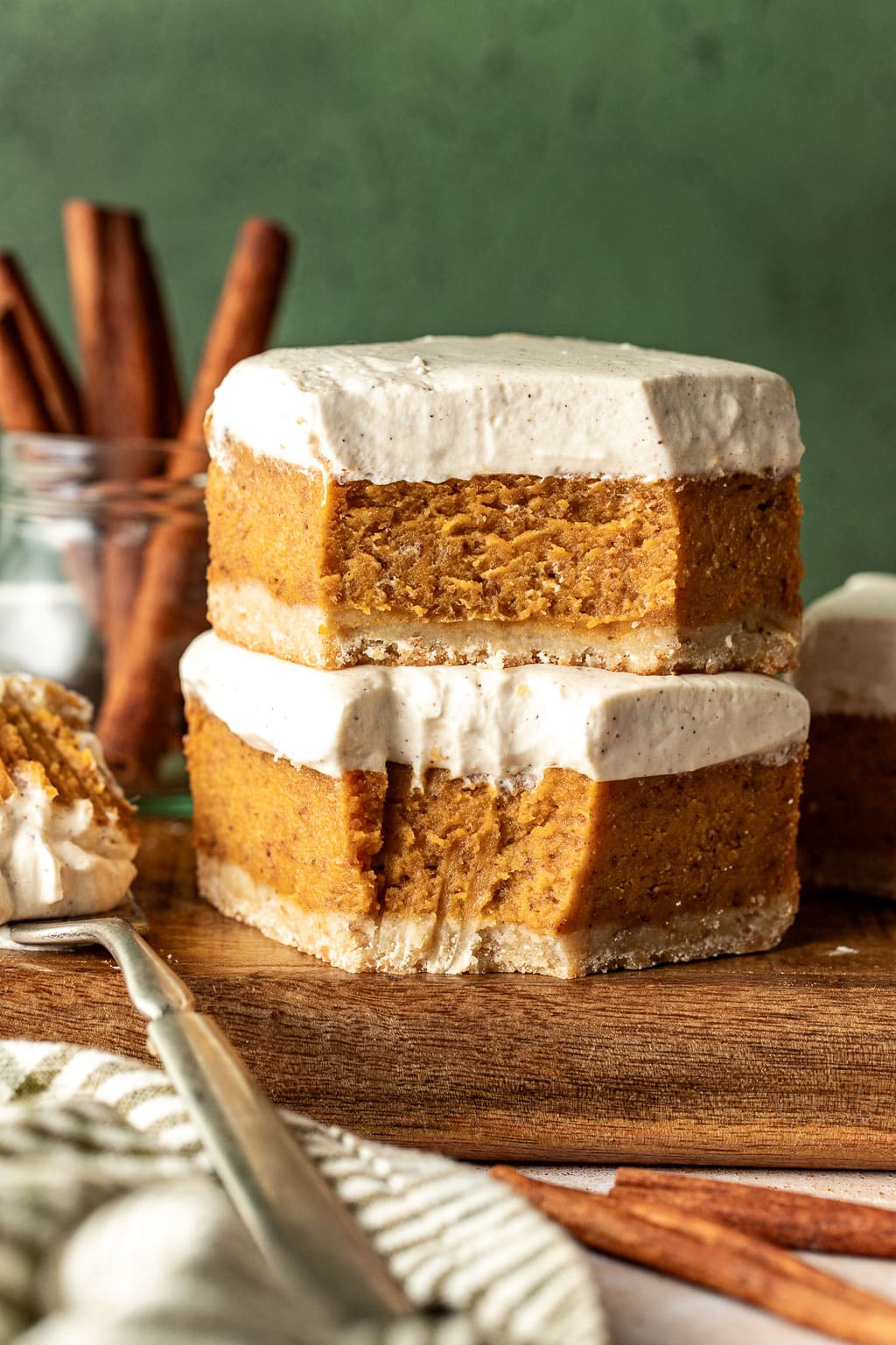 Two stacked sweet potato pie bars with bites missing. 