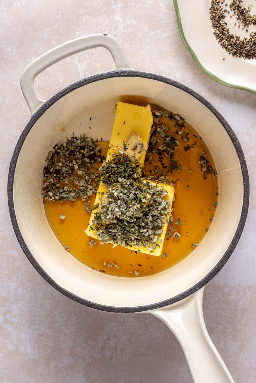 Ingredients for maple herb glaze in a saucepan. 