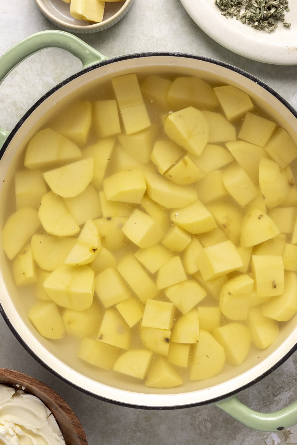 Cut potatoes in a pot of water. 