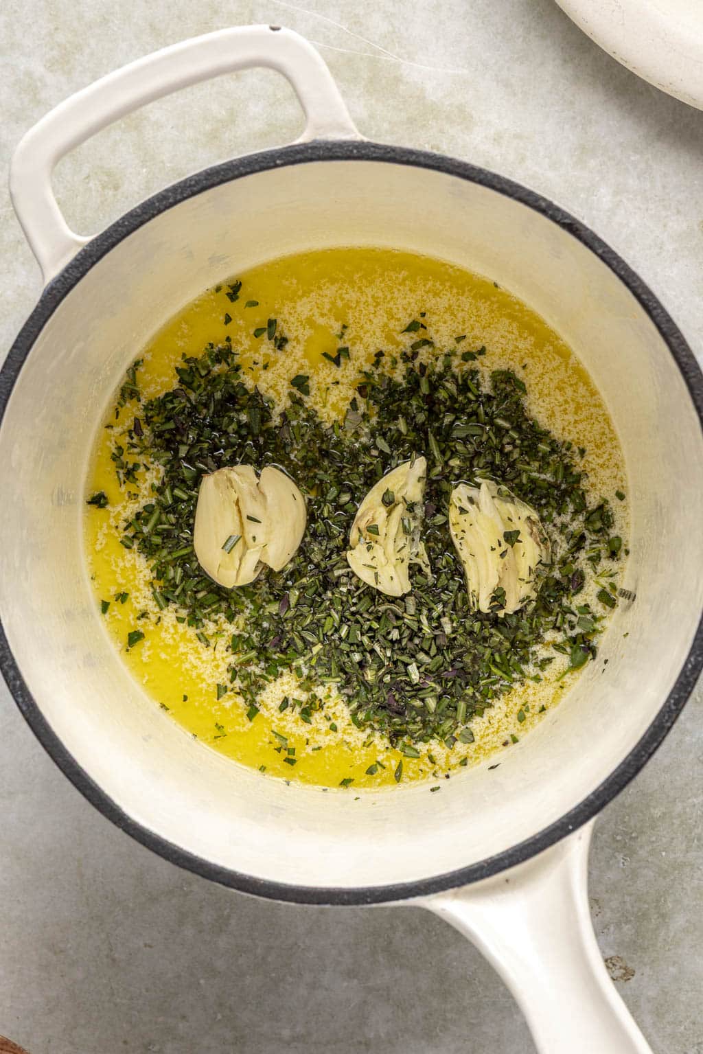 Garlic, herbs, and melted butter in a saucepan. 