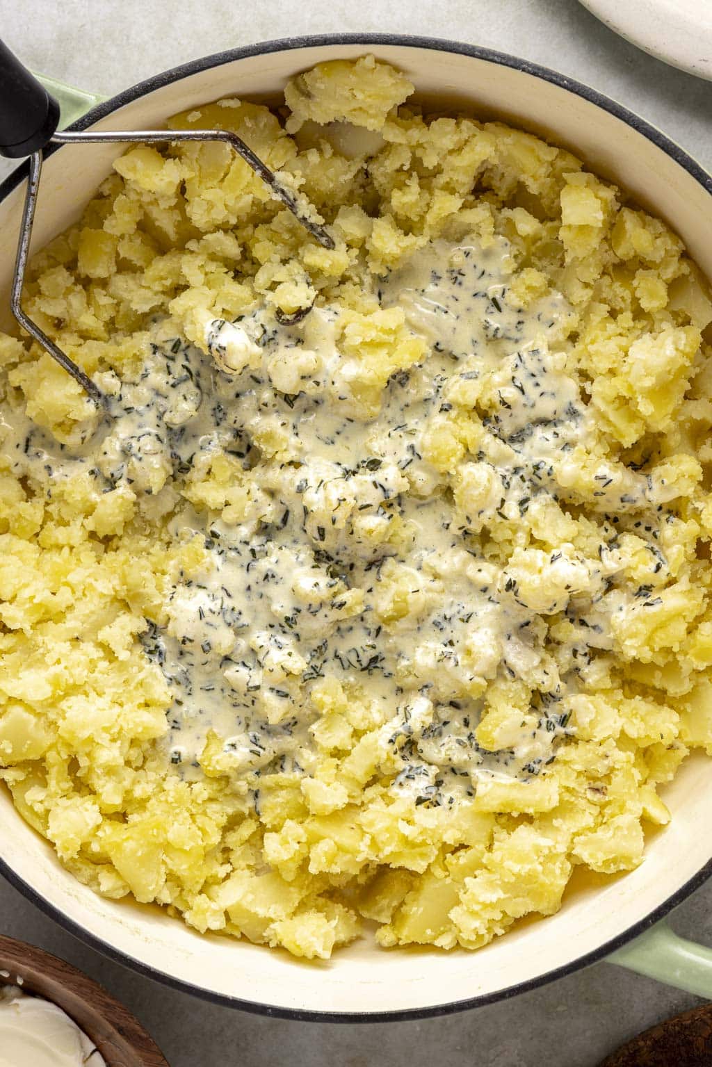 Process shot mashed potatoes being mashed. 