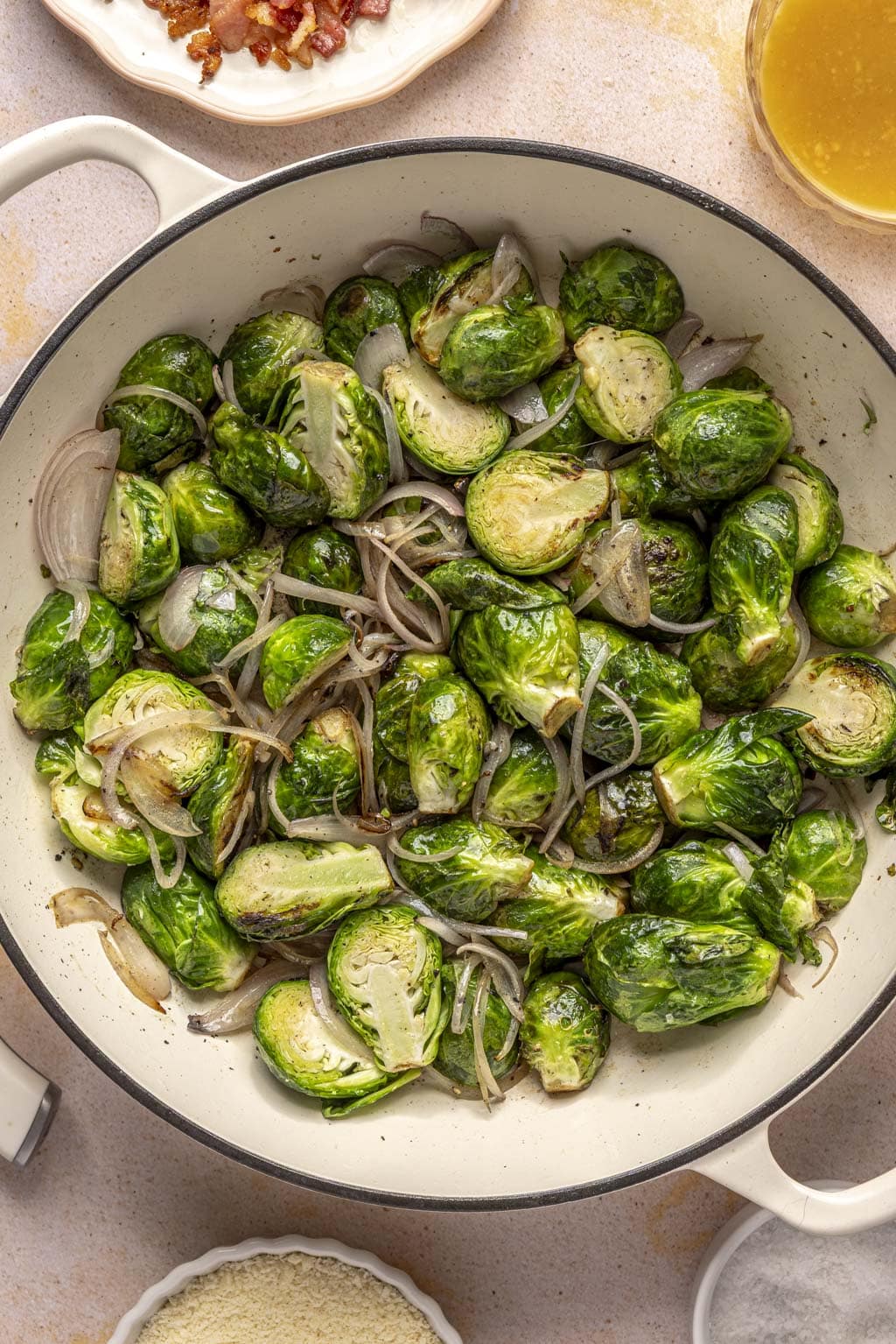 Brussels sprouts, bacon, and shallots in a Dutch oven. 