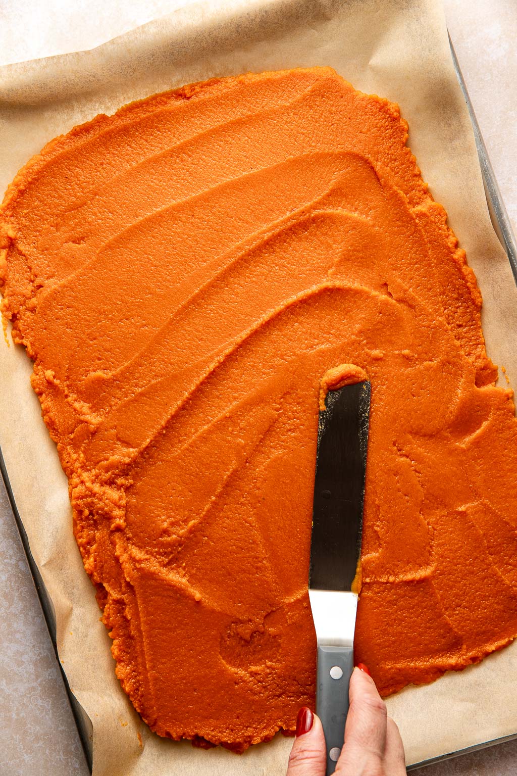 pumpkin puree spread on a baking sheet