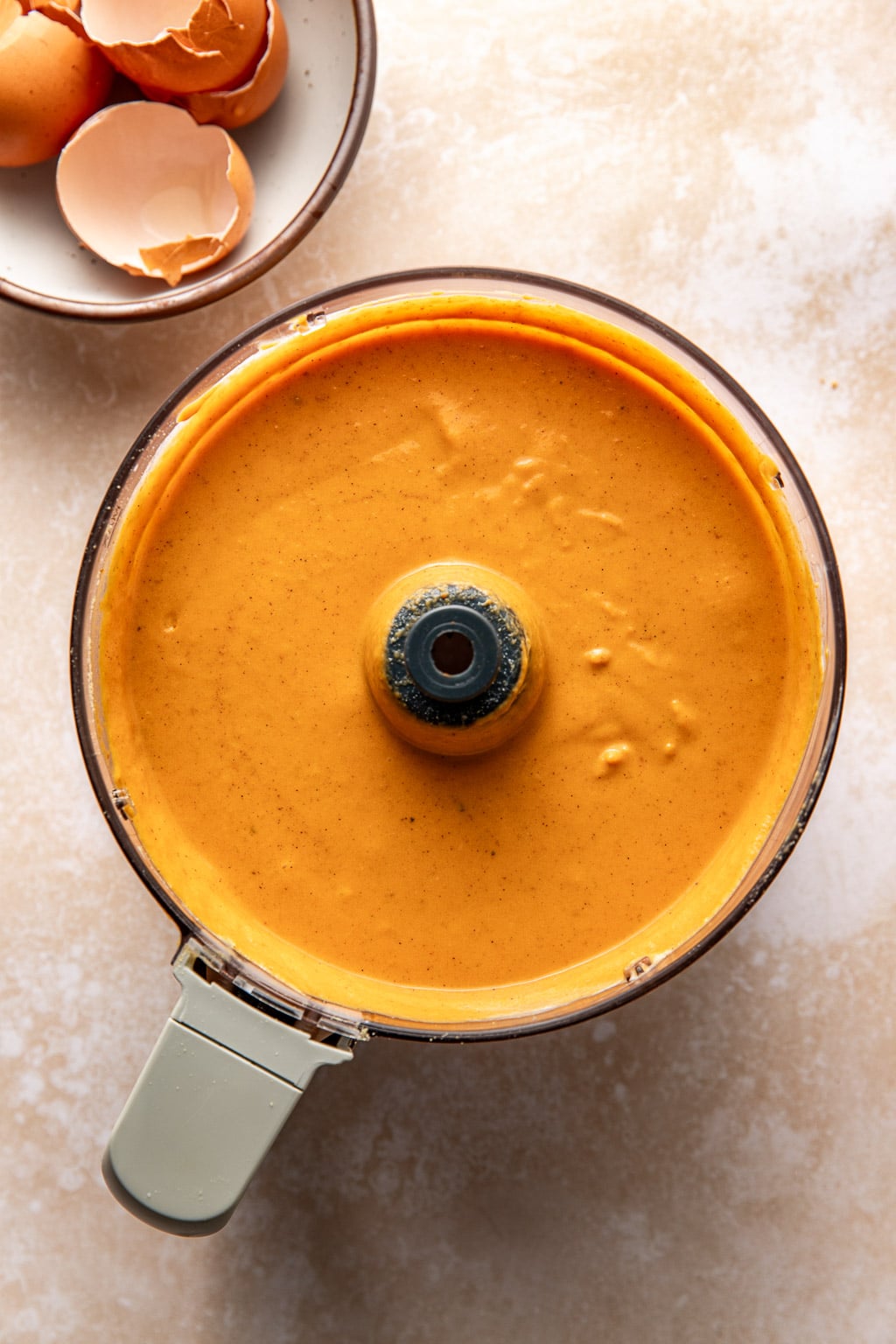 pumpkin pie filling in a food processor bowl after blending