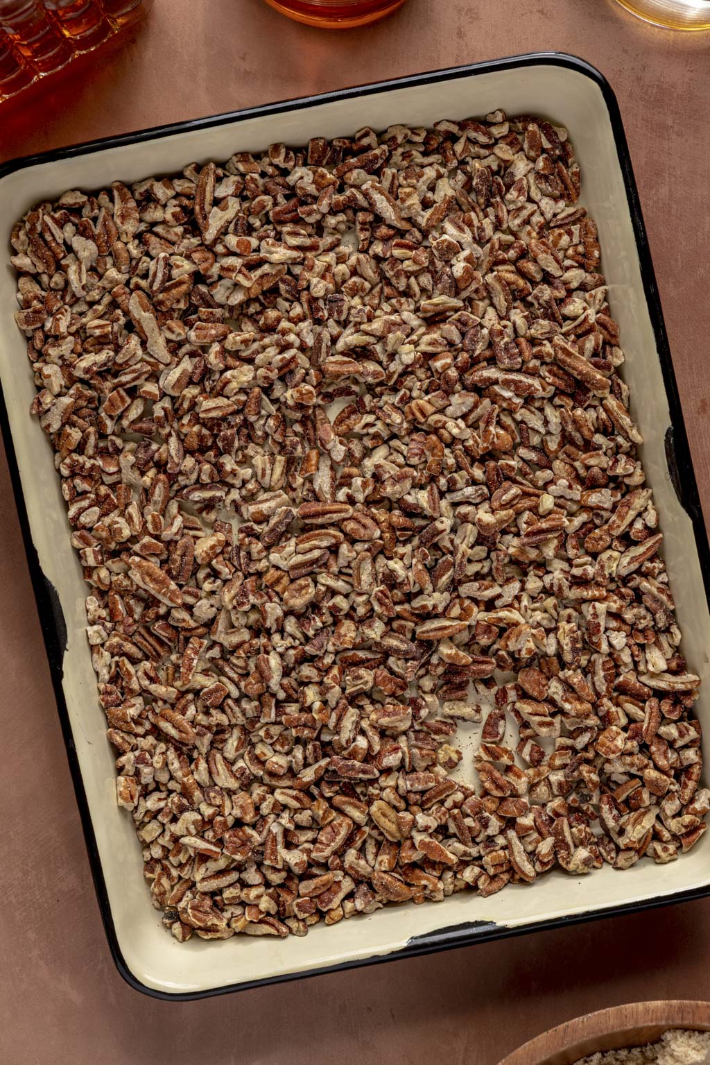 toasted pecans on a white baking sheet