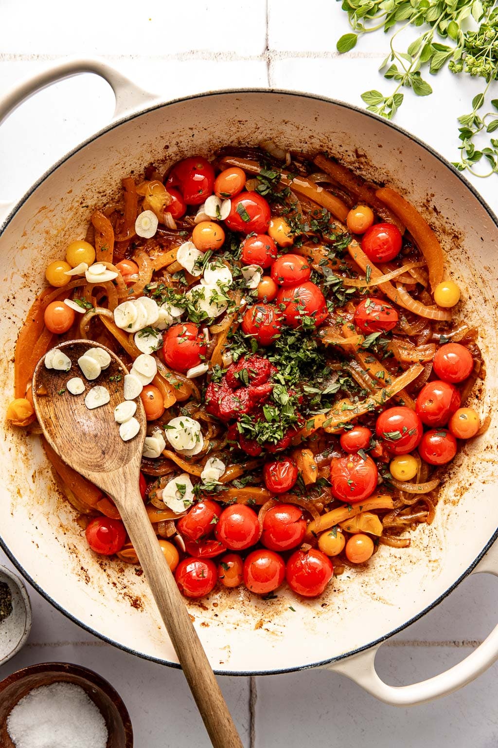 peppers, onion, tomatoes in a skillet with garlic and herbs