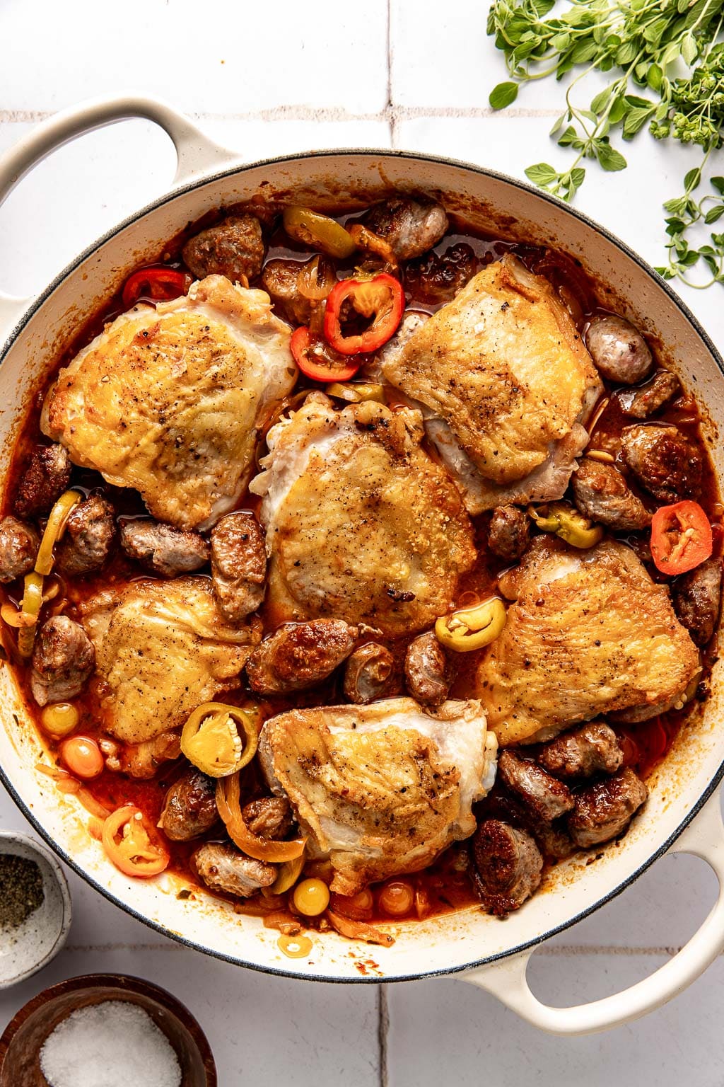 chicken scarpariello in the skillet before going into the oven