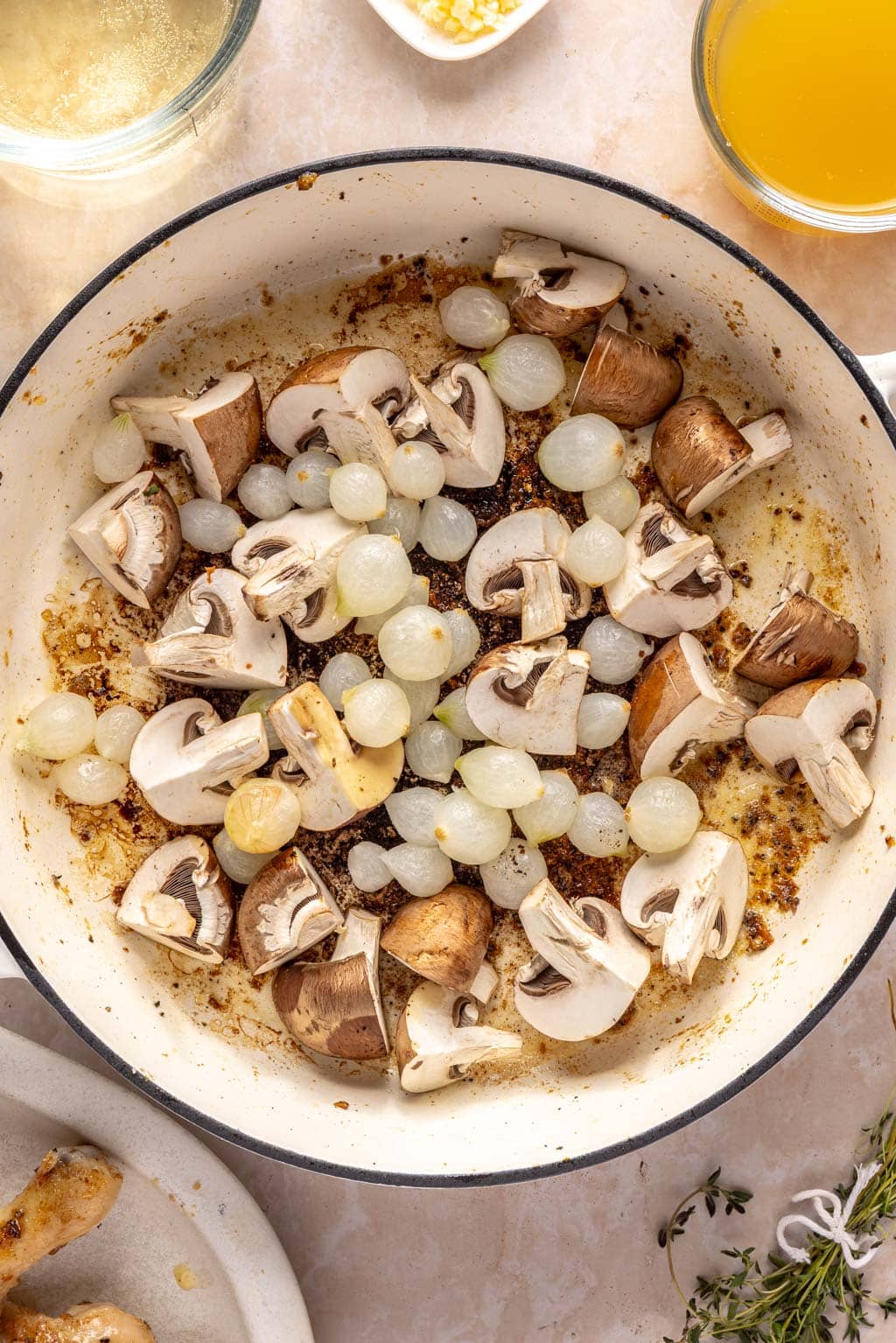 searing pearl onions and mushrooms in a skillet