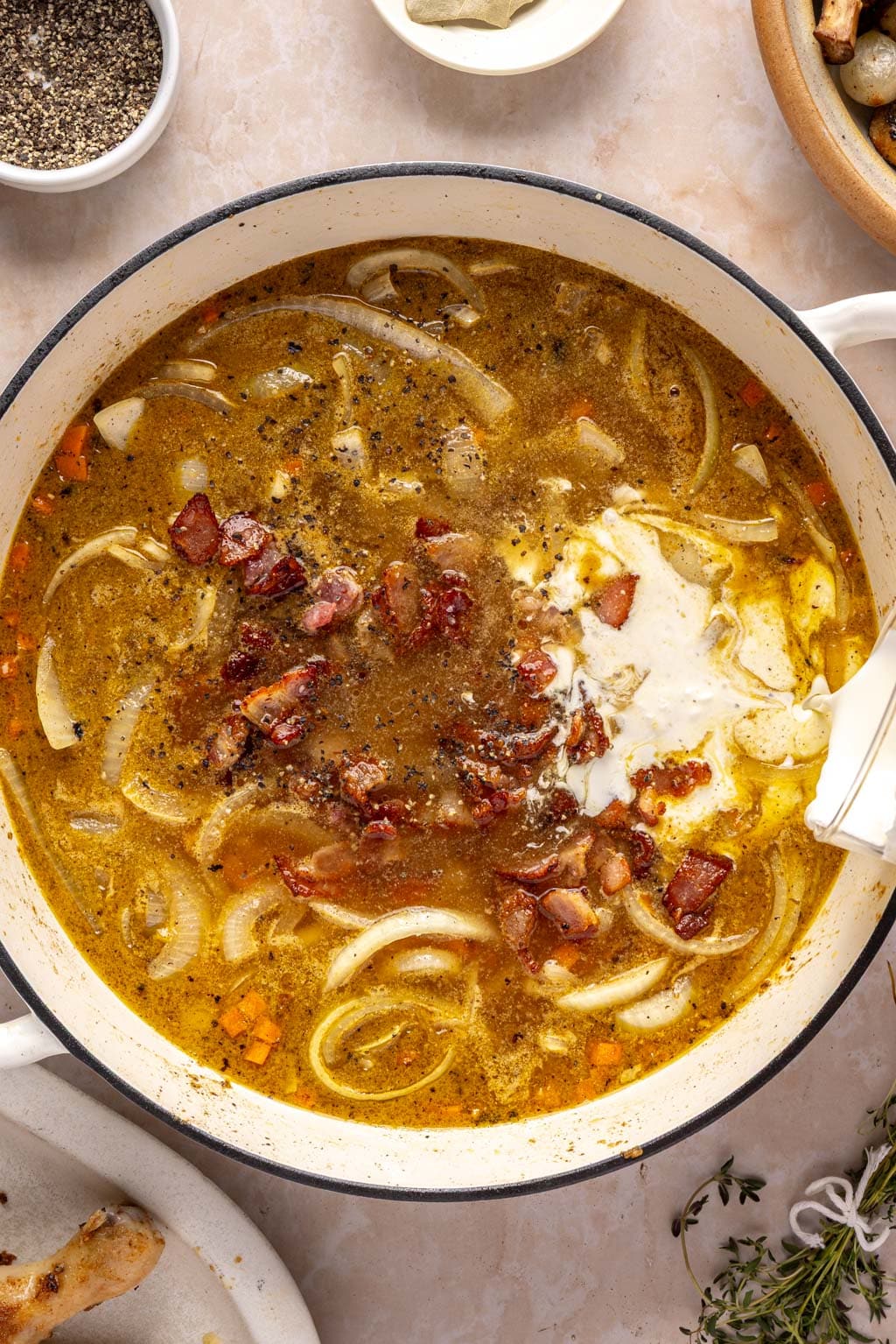 building the coq au vin braising sauce in a skillet