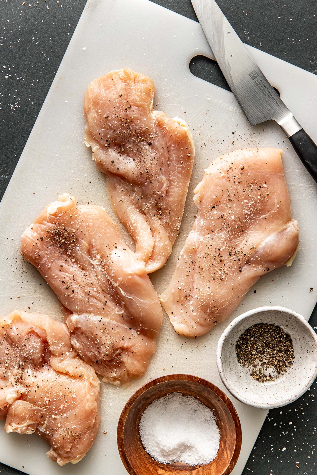 butterflied chicken breasts on a cutting board