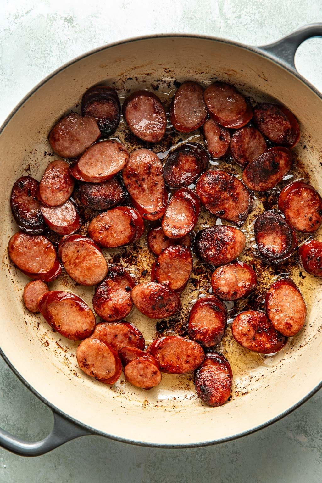 seared pork sausage in a dutch oven