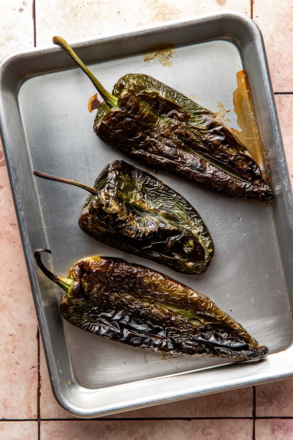 roasted poblano peppers on a baking sheet