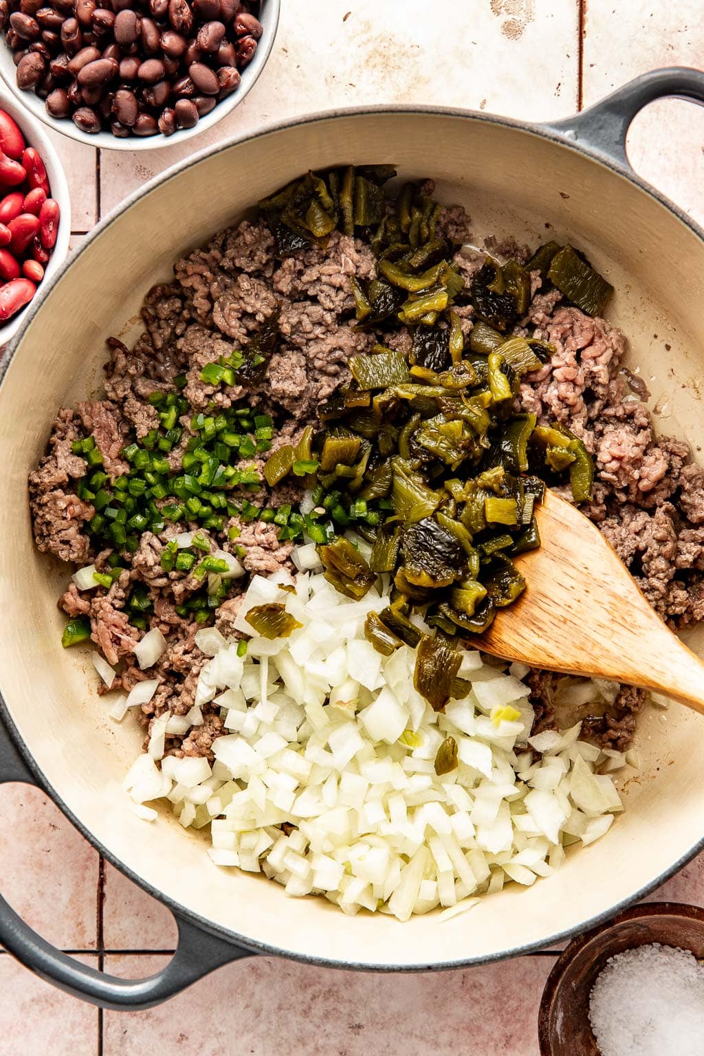 ground beef in a dutch oven with onions and peppers