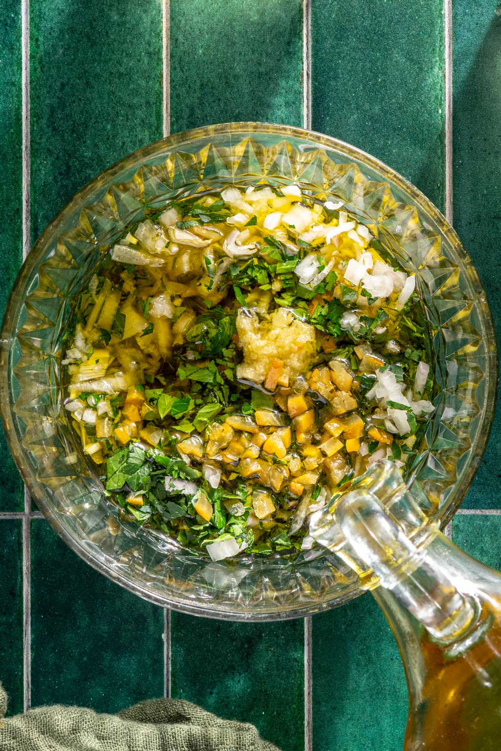 Olive oil being poured over the gremolata