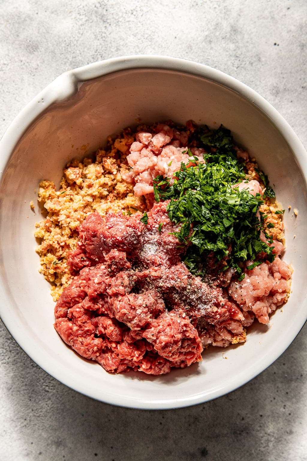 pepperoni meatball ingredients in a mixing bowl before mixing