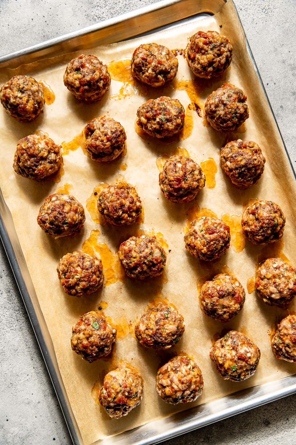pepperoni meatballs on a baking sheet after baking in the oven