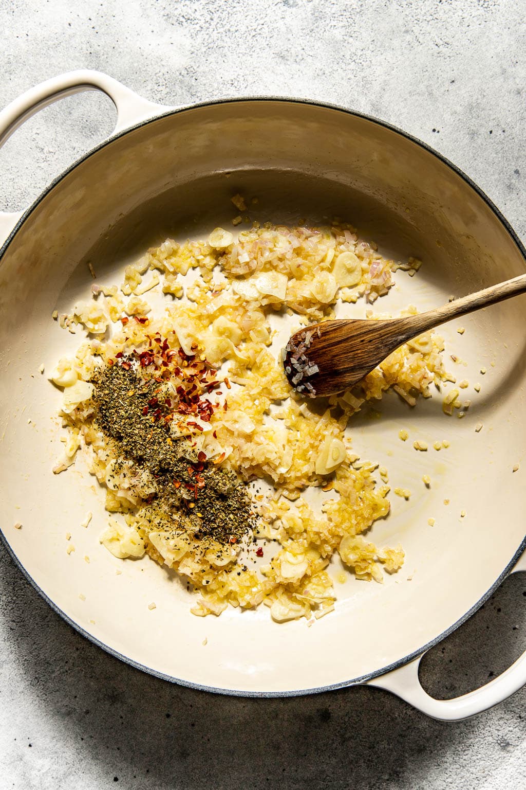 Shallot, garlic, and spices sautéing in a braiser