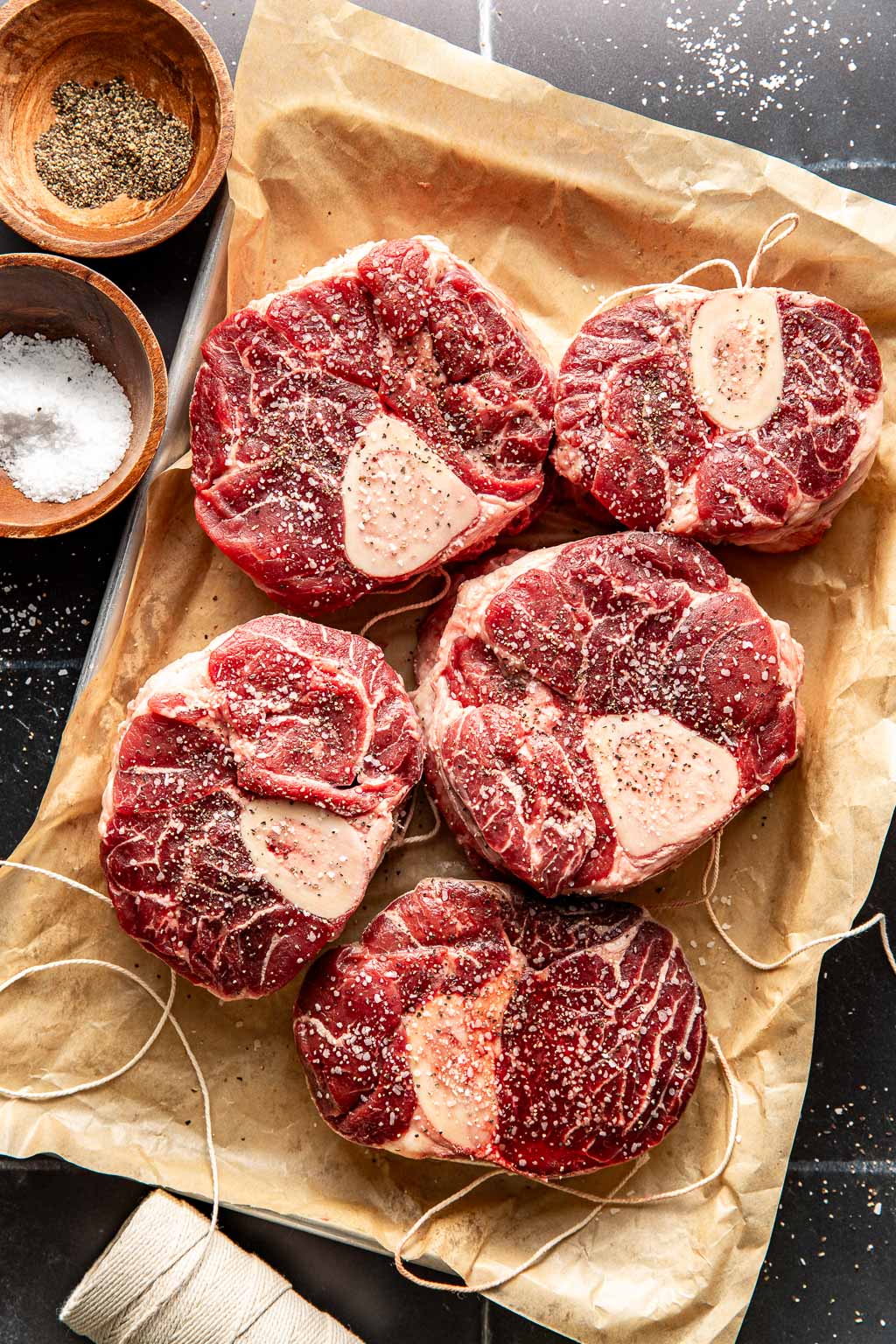 seasoned beef shanks on a baking sheet before searing