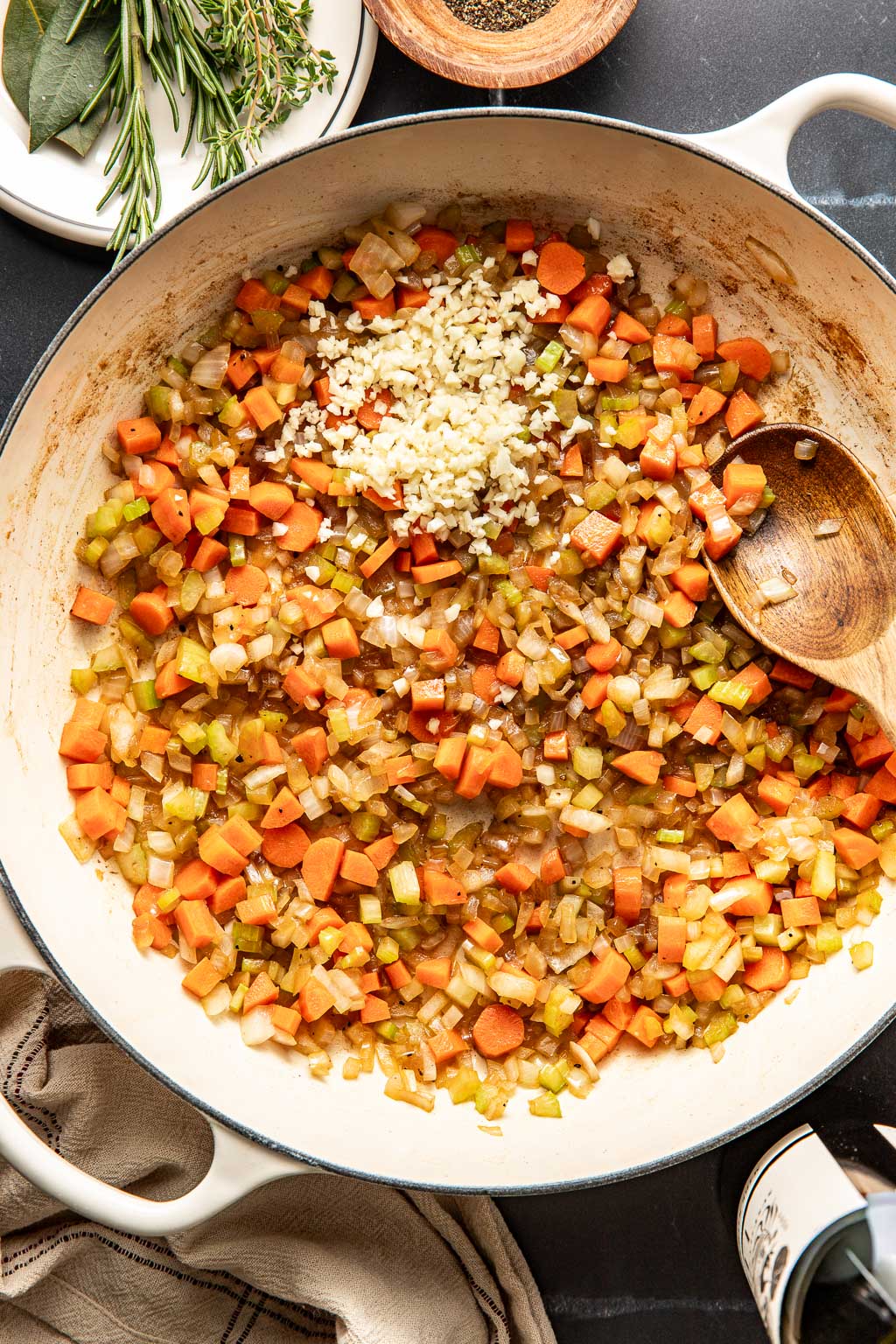 vegetables being sautéed in a braiser